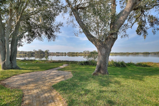 exterior space with a water view and a yard