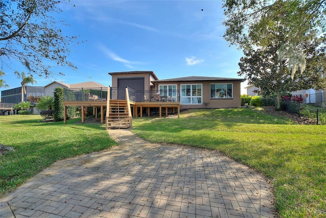 back of house with a lawn and a deck