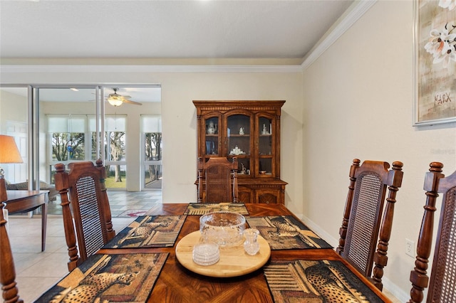 tiled dining space with ornamental molding and ceiling fan