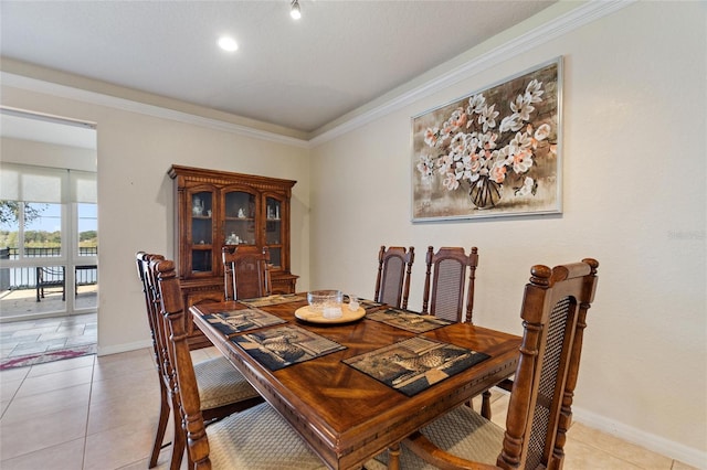 tiled dining space featuring ornamental molding