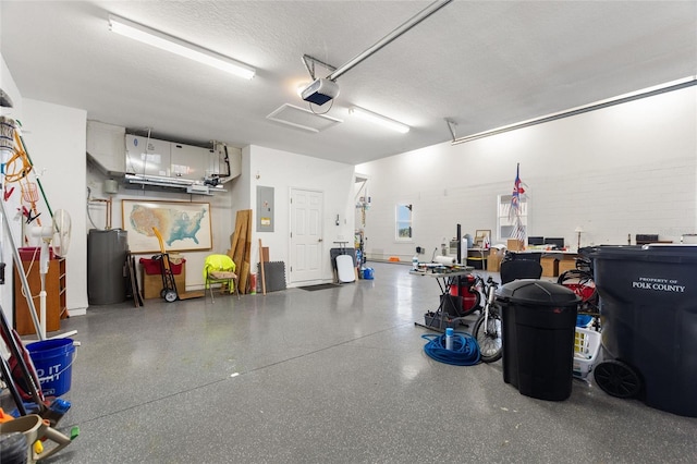 garage with a garage door opener and electric panel