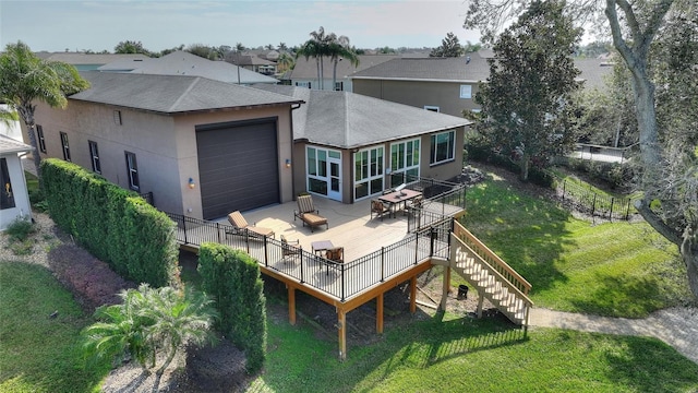 back of house with a wooden deck and a yard