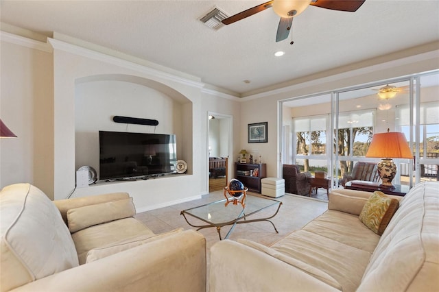 living room with ornamental molding and ceiling fan