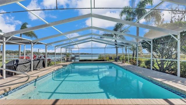 view of pool featuring a patio, a lanai, and a water view