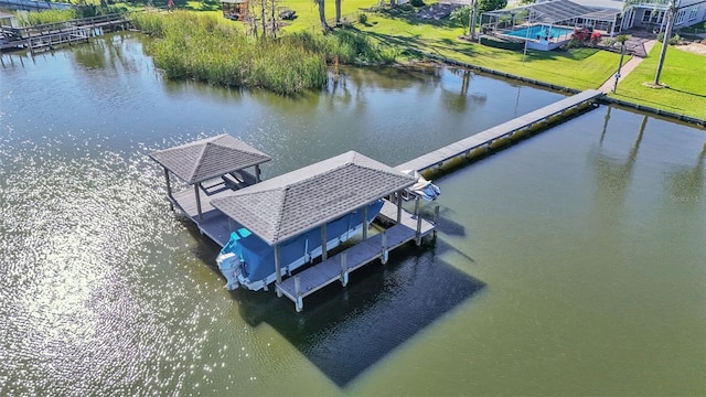 dock area with a yard and a water view