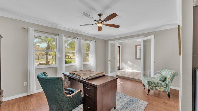 office space with ceiling fan, ornamental molding, and light wood-type flooring