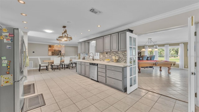 kitchen with stainless steel appliances, pendant lighting, gray cabinets, and light tile patterned floors