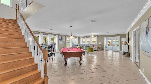 rec room with pool table, ornamental molding, a wealth of natural light, and light tile patterned floors