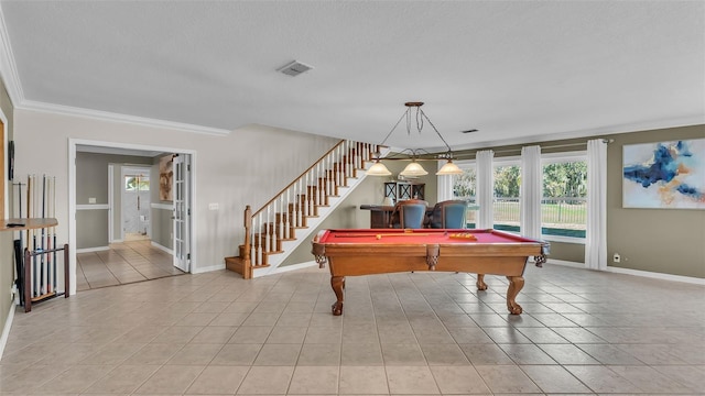 recreation room with light tile patterned flooring, a textured ceiling, and crown molding