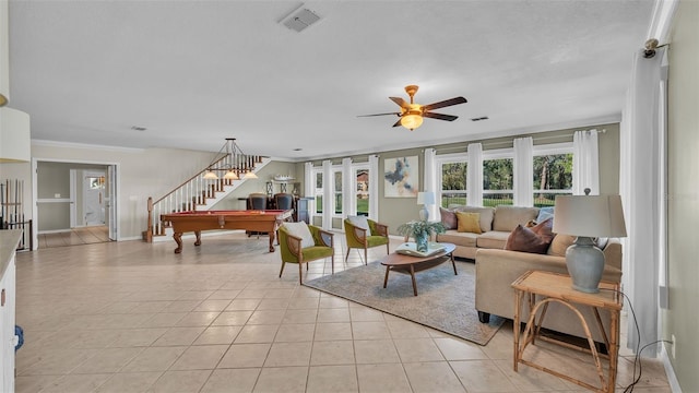 living room featuring light tile patterned floors, crown molding, french doors, and ceiling fan