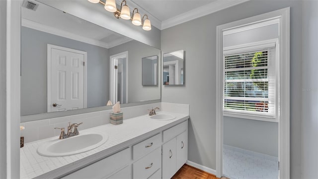 bathroom with ornamental molding, parquet floors, and vanity