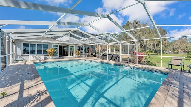 view of swimming pool featuring a patio area and glass enclosure