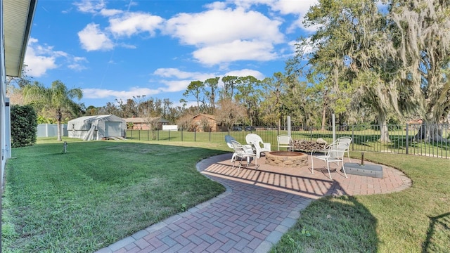 view of yard featuring a fire pit and a patio