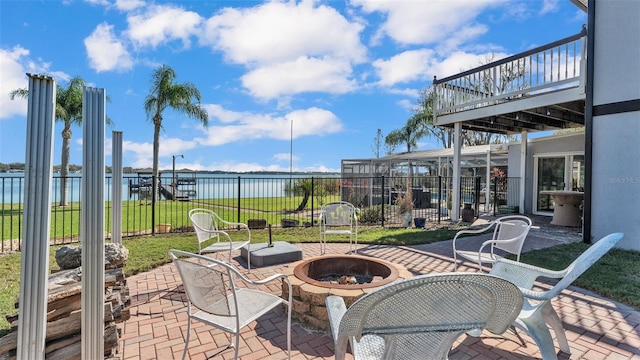 view of patio with a water view and an outdoor fire pit