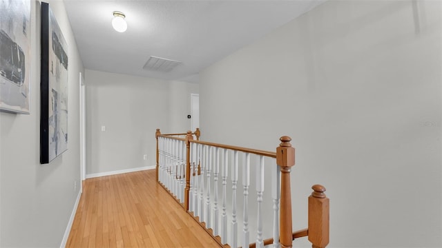 corridor with light hardwood / wood-style flooring