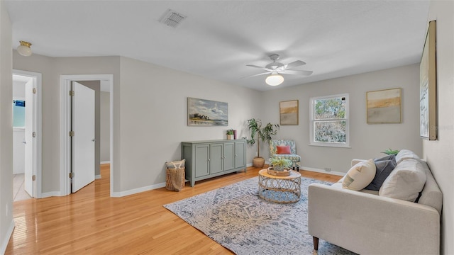 living room featuring ceiling fan and light hardwood / wood-style flooring