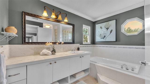 bathroom featuring crown molding, vanity, and tiled bath