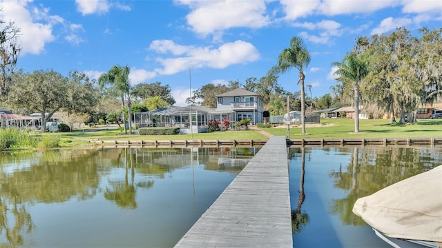 dock area featuring a water view and a yard