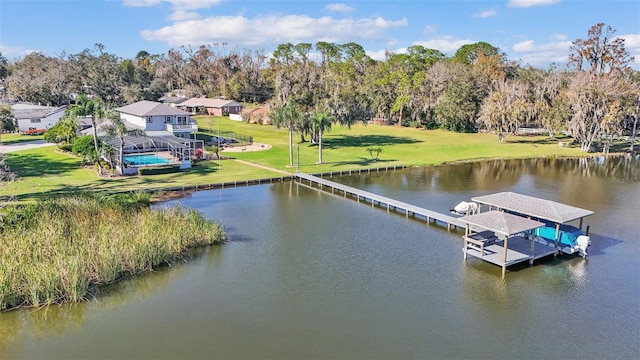 dock area with a water view, a yard, and glass enclosure