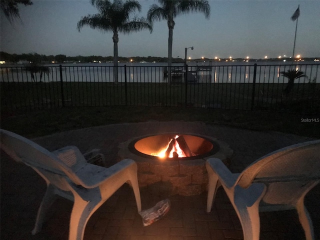 patio at twilight featuring a fire pit