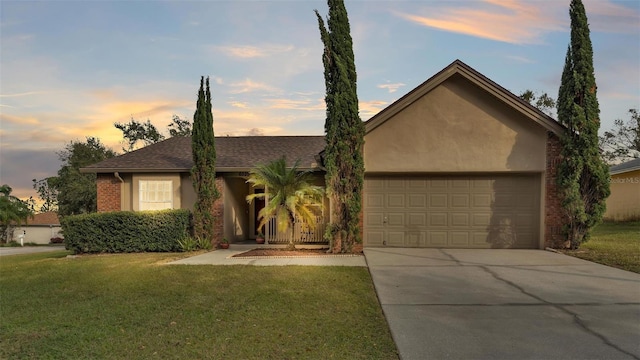 single story home with a lawn and a garage