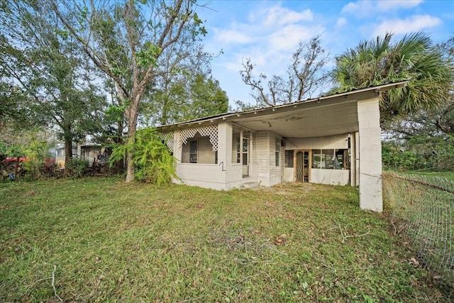 back of house with a yard and a carport