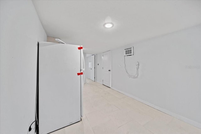 interior space with white fridge and a wall mounted AC