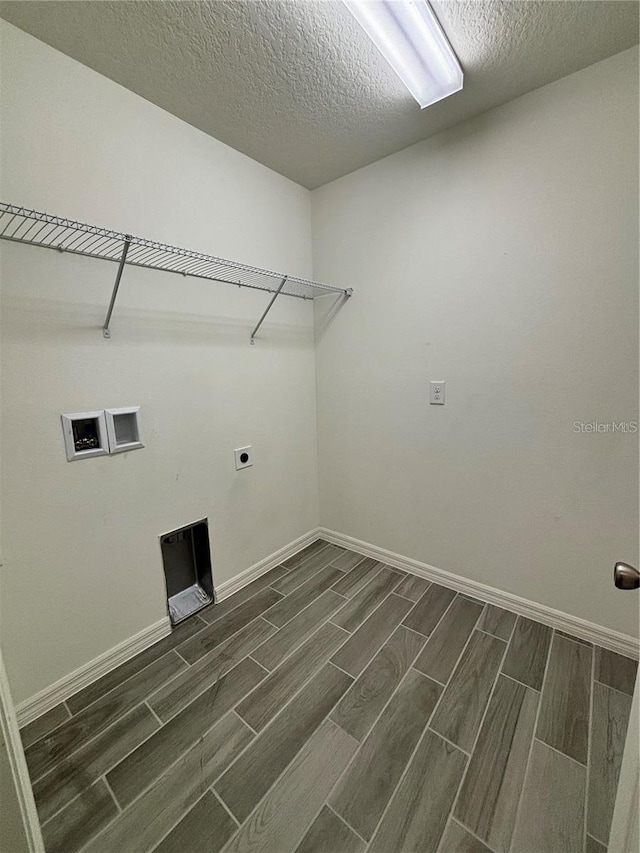 washroom featuring washer hookup, a textured ceiling, and hookup for an electric dryer