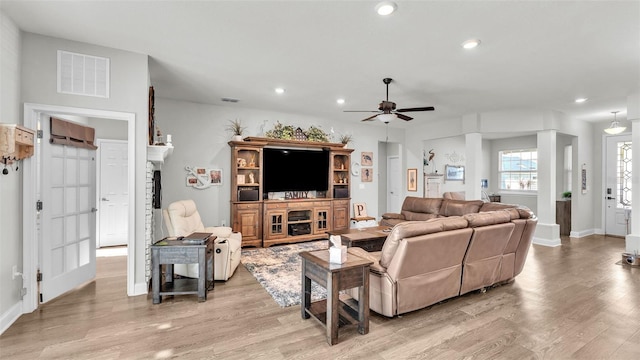 living room with ceiling fan and light hardwood / wood-style floors