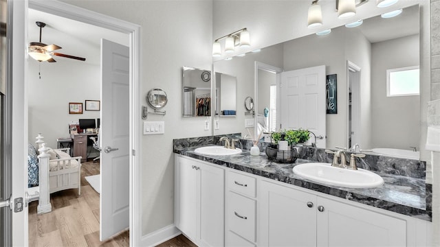 bathroom featuring ceiling fan, vanity, and wood-type flooring