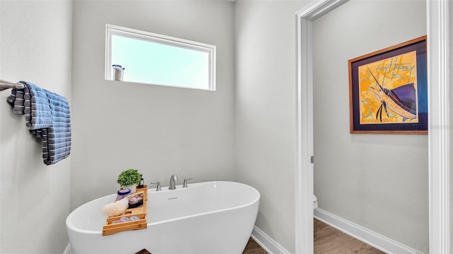 bathroom featuring hardwood / wood-style flooring and a tub