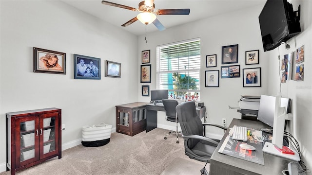 home office featuring light carpet and ceiling fan