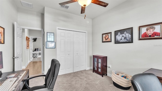 carpeted home office with ceiling fan