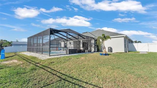 back of house with a yard, a pool, and glass enclosure