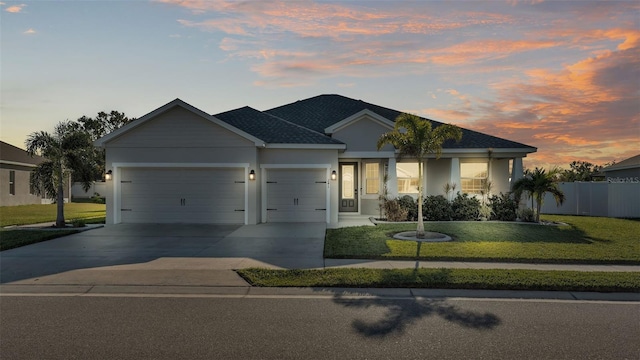 view of front of house featuring a yard and a garage