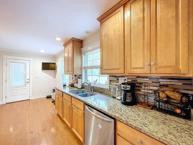 kitchen featuring dishwasher, backsplash, sink, light wood-type flooring, and light stone counters