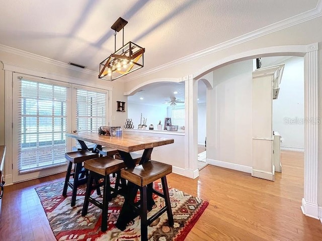 dining area featuring ceiling fan, hardwood / wood-style floors, and ornamental molding