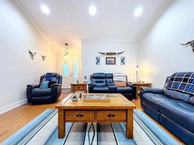 living room featuring hardwood / wood-style flooring and ornamental molding