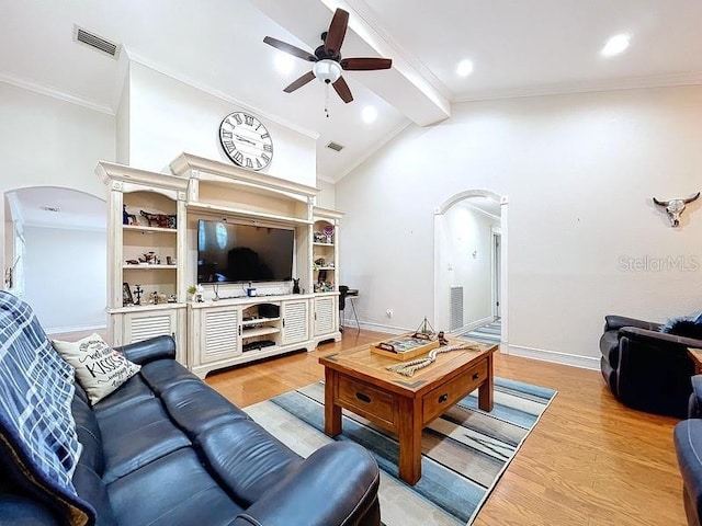 living room featuring lofted ceiling with beams, ceiling fan, crown molding, and light hardwood / wood-style flooring