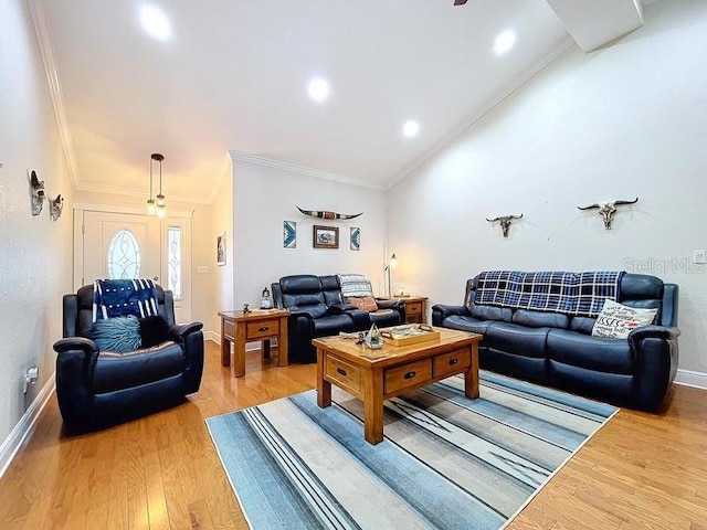 living room with hardwood / wood-style flooring, vaulted ceiling, and ornamental molding