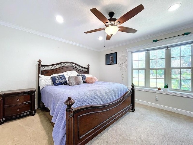 carpeted bedroom featuring ceiling fan and ornamental molding