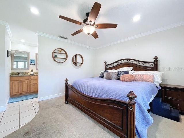 carpeted bedroom featuring ensuite bath, ceiling fan, crown molding, and sink