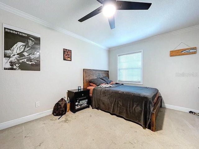 carpeted bedroom with ceiling fan and crown molding