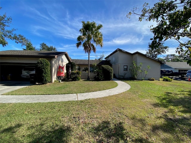 ranch-style home with a garage and a front lawn