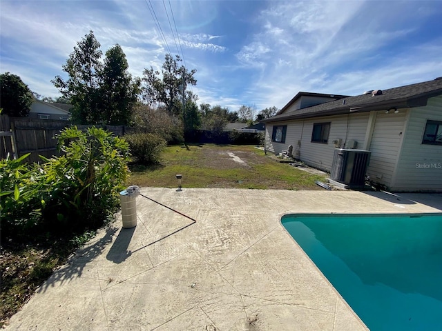 view of swimming pool featuring a yard, cooling unit, and a patio area