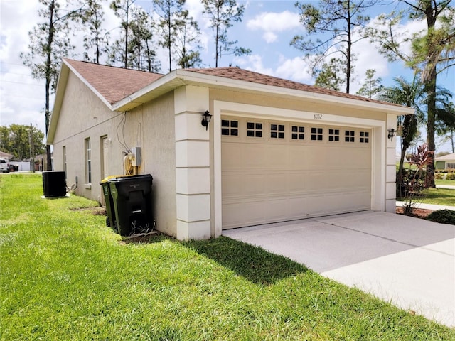 view of side of property featuring a lawn, cooling unit, and a garage