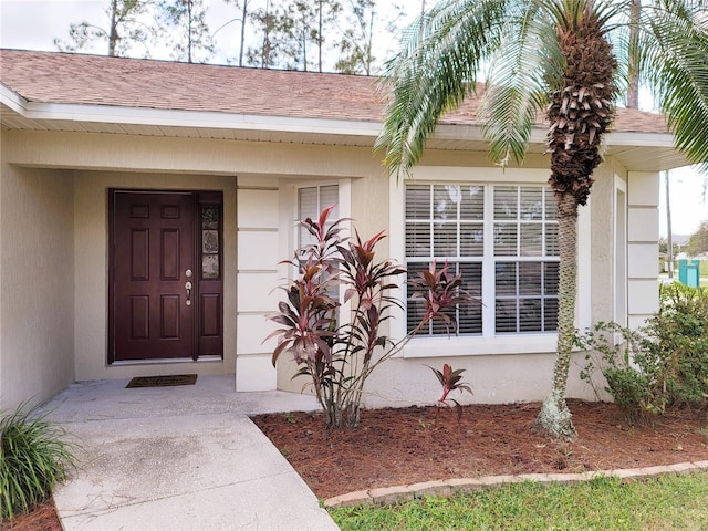 view of exterior entry with covered porch