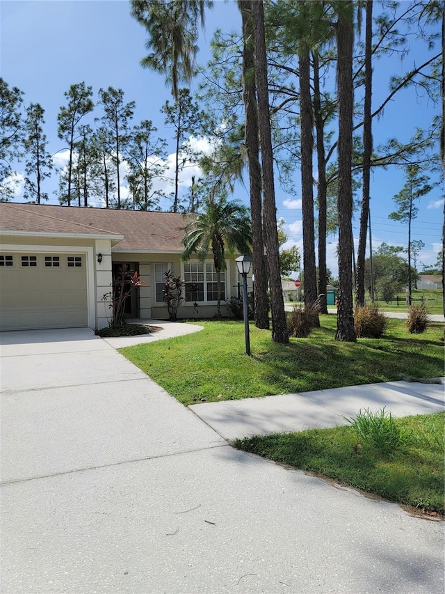 view of front of property with a front yard and a garage