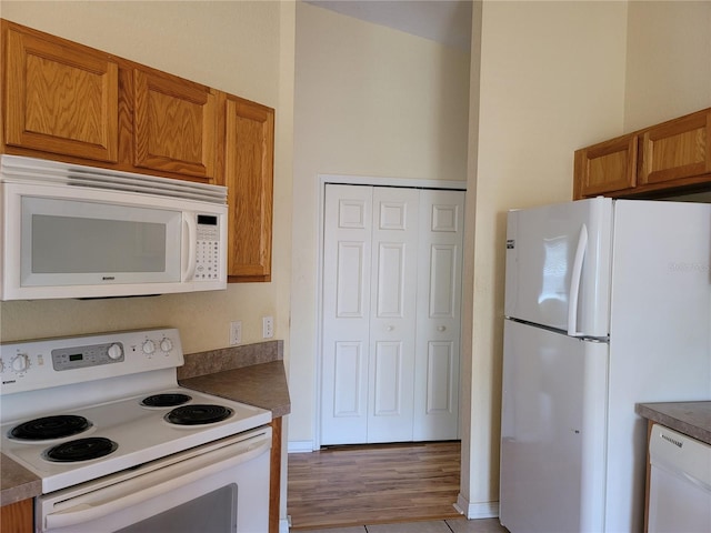 kitchen featuring white appliances and light tile patterned floors