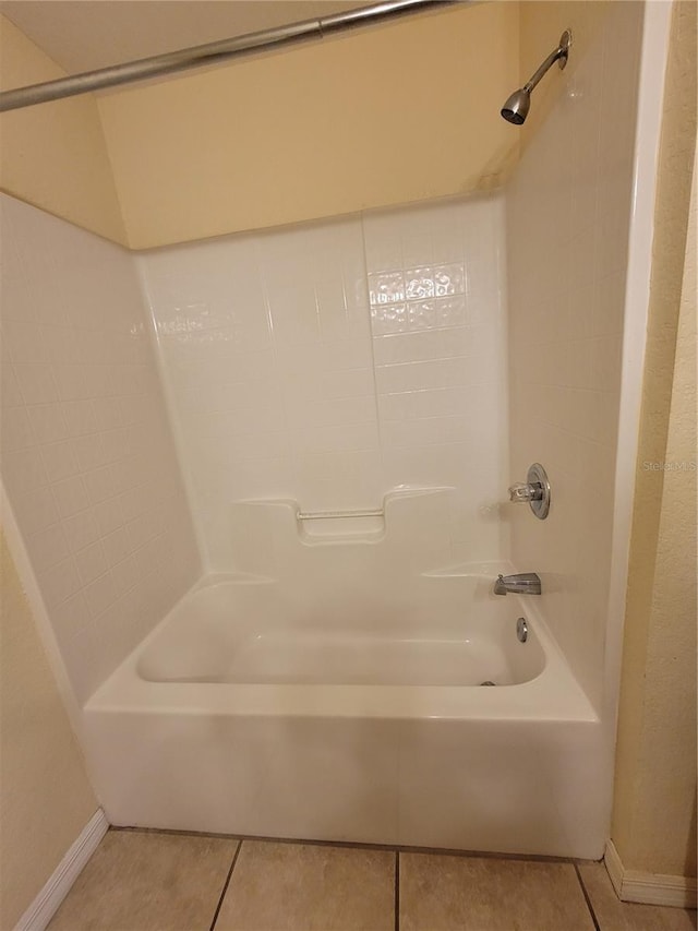 bathroom with tile patterned flooring and shower / washtub combination